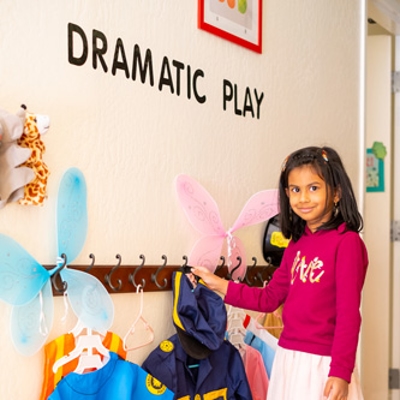 Child near coatrack Photo